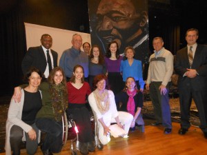Members of the Reading Public Schools Administration, Reading School Committee, Reading Human Relations Advisory Council, students, and members of the Leonard Zakim family pose with Rob Surrette and one of the portraits that he created at the event