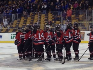 RMHS Girls Hockey Team celebrating their hard earned victory